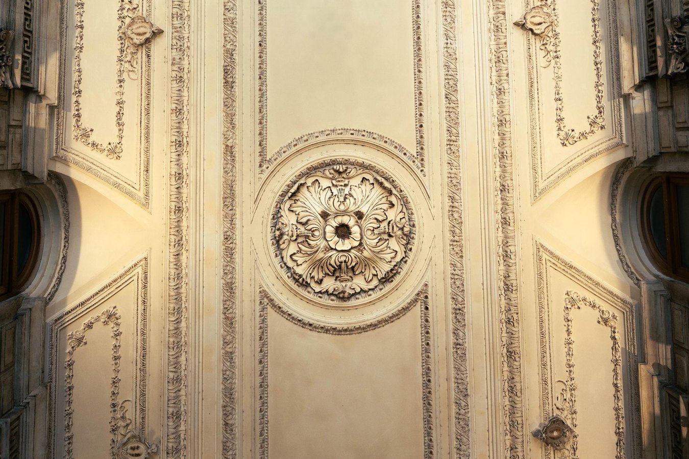 Artisan craftsperson working on ornamental plaster restoration overhead